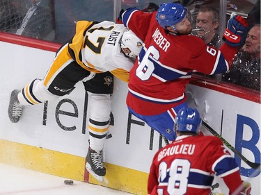 Montreal Canadiens defenceman Shea Weber (6) puts Pittsburgh Penguins Brian Rust into the boards, during first period NHL action in Montreal on Tuesday October 18, 2016.