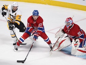 Montreal Canadiens defenceman Mikhail Sergachev (22) takes puck away from Pittsburgh Penguins centre Matt Cullen (7) in front of goalie Al Montoya during first period NHL action in Montreal on Tuesday October 18, 2016.