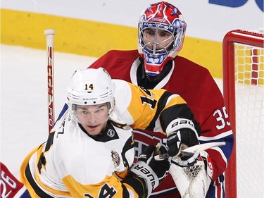 Montreal Canadiens goalie Al Montoya tries to push away Pittsburgh Penguins left wing Chris Kunitz (14), during first period NHL action in Montreal on Tuesday October 18, 2016.