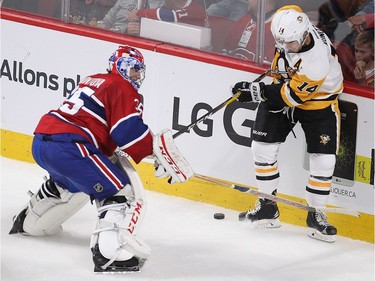 Montreal Canadiens goalie Al Montoya goes behind his net with Pittsburgh Penguins Brian Rust during first period NHL action in Montreal on Tuesday October 18, 2016.