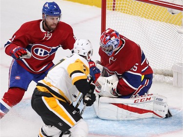 Montreal Canadiens goalie Al Montoya stops the puck next to Pittsburgh Penguins centre Matt Cullen (7) and Montreal Canadiens' Shea Weber (6) during first-period NHL action in Montreal on Tuesday, Oct. 18, 2016.