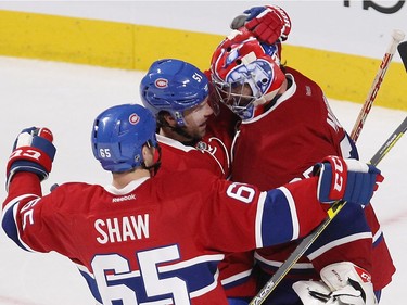 Montreal Canadiens goalie Al Montoya celebrates his shutout against the Pittsburgh Penguins with teammates David Desharnais (51) and Andrew Shaw (65) following third period NHL action in Montreal on Tuesday October 18, 2016.