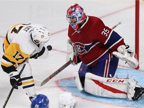 Montreal Canadiens goalie Al Montoya stops puck on Pittsburgh Penguins Brian Rust during third period NHL action in Montreal on Tuesday October 18, 2016.