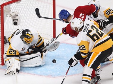 Montreal Canadiens right wing Alexander Radulov (47) comes in close to Pittsburgh Penguins goalie Marc-André Fleury, while being closely checked by Pittsburgh Penguins' Carl Hagelin (62) and Kris Letang (58),  during first period NHL action in Montreal on Tuesday October 18, 2016.