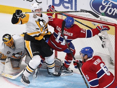 Montreal Canadiens right wing Brendan Gallagher (11) goes into the net of Pittsburgh Penguins goalie Marc-André Fleury after being hit by Pittsburgh Penguins defenceman Ian Cole (28) during second period NHL action in Montreal on Tuesday October 18, 2016.
