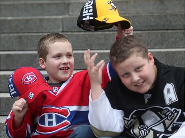 Nathan Furlong, 8, swipes the Pittsburgh Penguins hat from brother Nicholas, 12, outside the Bell Centre prior to the season opener of the Montreal Canadiens on Tuesday October 18, 2016. The family is visiting from Bonavista Bay, Nfld.