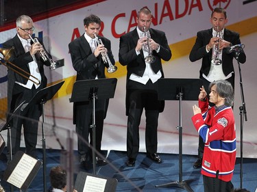 OSM conductor Ken Nagano and members of the orchestra play the national anthem prior to first period NHL action in Montreal on Tuesday October 18, 2016.