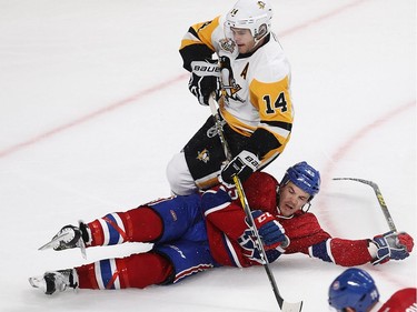 Pittsburgh Penguins Brian Rust goes over Montreal Canadiens centre Andrew Shaw (65), during third period NHL action in Montreal on Tuesday October 18, 2016.