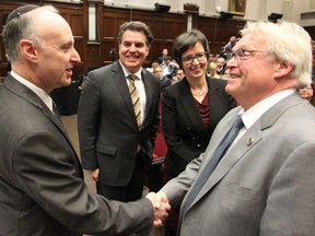 Quebec Health Minister Gaétan Barrette, right, shakes hands with CIUSS West-Central head Lawrence Rosenberg, while CIUSS West Island head Benoit Morin and Martine Alfonso Interim President of the MUHC on Wednesday October 19, 2016. The minister met with the health officials who presented their competing visions for a merger of west-end health-care services on the island of Montreal.