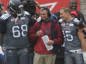Montreal Alouettes head coach Jacques Chapdelaine is all smiles after victory against the Toronto Argonauts in Montreal on Sunday Oct. 2, 2016. With Chapdelaine are players Philip Blake (68) and Samuel Giguere (15).