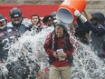 Alouettes head coach Jacques Chapdelaine receives a bucket of water by quarterback Rakeem Cato, right, and Duron Carter, smiling, while teammates Martin Bédard (37) and Jeff Perrett (54) look on after Chapdelaine received his first victory as the Alouettes head coach after the defeated the Toronto Argonauts on Sunday Oct. 2, 2016.