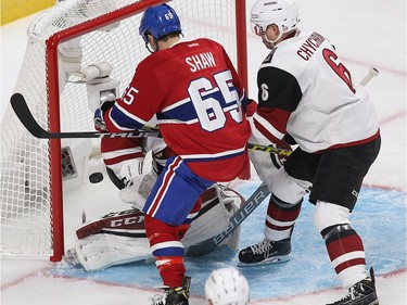 Montreal Canadiens centre Andrew Shaw (65) looks at puck past by Arizona Coyotes defenceman Jakob Chychrun (6) and goalie Louis Domingue during first period NHL action in Montreal on Thursday October 20, 2016.