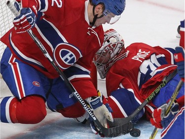 Montreal Canadiens defenceman Mikhail Sergachev (22) plays goalie while goalie Carey Price is caught off balance during second period NHL action in Montreal on Thursday October 20, 2016.