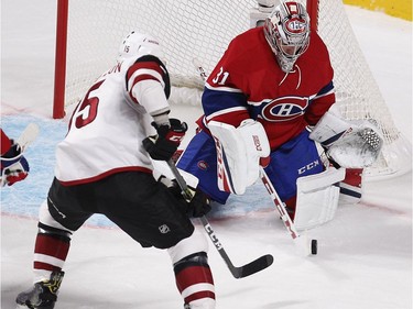 Montreal Canadiens goalie Carey Price stops puck in front of Arizona Coyotes Brad Richardson (15) during first period NHL action in Montreal on Thursday October 20, 2016.