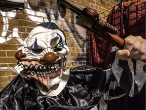 Julie Brassard tries on a killer-clown costume at Crazy Halloween on Ste-Catherine St. W. The "creepy clown" phenomenon started in the United States and has spread recently to Quebec.