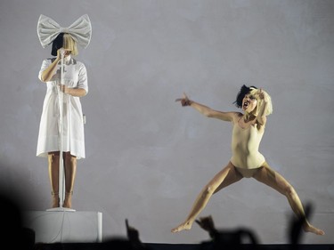 Australian musician Sia Furler, left, performs as part of her Nostalgic for the Present Tour at the Bell Centre in Montreal on Sunday, Oct. 23, 2016.