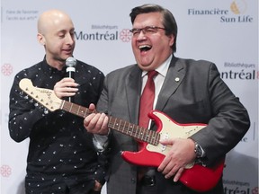Mayor Denis Coderre has some fun with Simple Plan's Jeff Stinco on Monday at the unveiling of the musical instrument lending program.