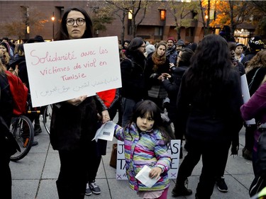 Amel Zaazaa holds her daughter's hand as they take part in a protest to denounce rape culture at Place Émilie-Gamelin on Wednesday, Oct, 26, 2016.
