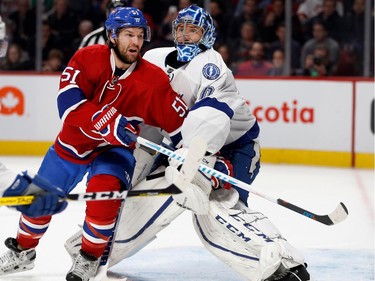 Montreal Canadiens centre David Desharnais gets caught up with Tampa Bay Lightning goalie Ben Bishop during NHL action at the Bell Centre in Montreal on Thursday October 27, 2016.