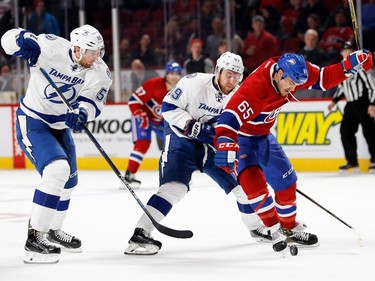 Montreal Canadiens Andrew Shaw wrestles the puck away from Tampa Bay Lightning defenceman Braydon Coburn, left, and Tampa Bay Lightning defenceman Nikita Nesterov during NHL action at the Bell Centre in Montreal on Thursday October 27, 2016. Shaw scored in an empty net but the goal was reversed because of a penalty.