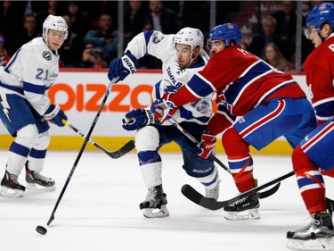 Montreal Canadiens defenceman Greg Pateryn, 2nd from right, blocks Tampa Bay Lightning centre Cédric Paquette during NHL action at the Bell Centre in Montreal on Thursday October 27, 2016. Tampa Bay Lightning centre Brayden Point, left, and Montreal Canadiens defenceman Nathan Beaulieu look on.