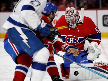 Montreal Canadiens goalie Carey Price makes a save as Montreal Canadiens left wing Max Pacioretty blocks Tampa Bay Lightning left wing Jonathan Drouin from getting to the net during NHL action at the Bell Centre in Montreal on Thursday October 27, 2016.