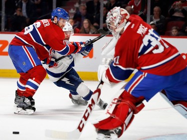 Montreal Canadiens goalie Carey Price plays the puck as Montreal Canadiens defenceman Shea Weber blocks Tampa Bay Lightning centre Tyler Johnson during NHL action at the Bell Centre in Montreal on Thursday October 27, 2016.