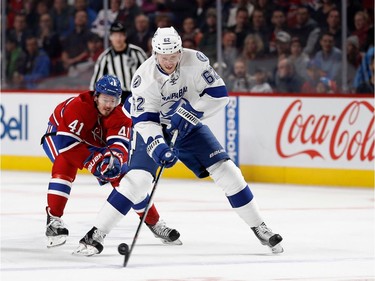 Tampa Bay Lightning defenceman Andrej Sustr takes the puck from Montreal Canadiens left wing Paul Byron during NHL action at the Bell Centre in Montreal on Thursday October 27, 2016.