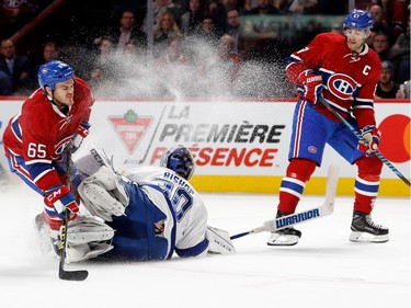Tampa Bay Lightning goalie Ben Bishop crashes into Montreal Canadiens forward Andrew Shaw, left, as Montreal Canadiens left wing Max Pacioretty looks on during NHL action at the Bell Centre in Montreal on Thursday October 27, 2016.