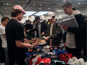 Kyle Oberfeld, left, sells a pair a sneakers to a customer during the Sole Exchange Canada "Spook-Tacular Sole Swap" event on Saturday, Oct. 29, 2016.