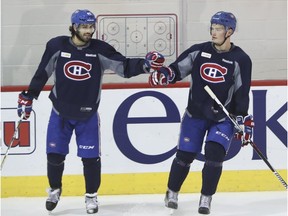 Defenceman Mark Barberio, left, of the Montreal Canadiens congratulates Mikhail Sergachev after the fellow blue-liner scored a goal during practice at the Bell Sports Complex in Brossard near Montreal Monday, October 3, 2016. Barberio was put on waivers by the Canadiens Wednesday, while Sergachev will start Thursday against the Maple Leafs in the Habs' final pre-season game.