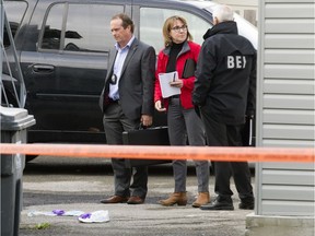 Investigators from the Bureau des enquêtes indépendantes (BEI) survey the scene of a police shooting in October 2016 in Montreal.