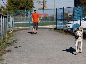 Shamrock looks to play ball as Quentin Leroy interacts with the dog he is considering adopting at SPCA L'Ouest de L'Ile in Vaudreuil on Monday October 3, 2016. The city of Vaudreuil-Dorion has ordered the SPCA to take down its dog enclosure. (Allen McInnis / MONTREAL GAZETTE) ORG XMIT: 57243
