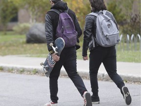 Students dressed in black walk toward École secondaire Cavelier-De LaSalle Oct. 31, 2016.