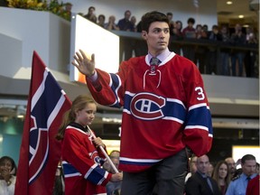 Canadiens goaltender Carey Price waves to the crowd during NHL team's introduction of the 2016-17 edition of the Montreal Canadiens at Complexe Desjardins in Montreal, Oct. 5, 2016.