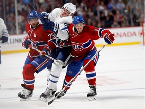 Toronto Maple Leafs Auston Matthews, centre, forces his way between and past Montreal Canadiens defenceman Andrei Markov, left, and centre Torrey Mitchell during pre-season NHL action at the Bell Centre on Thursday Oct. 6, 2016.