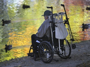 Bob Coolidge looks at ducks in the pond at Westmount Park on Friday, October 7, 2016. He's been coming from his nearby seniors residence to observe the growth of the park ducks since June. His caregiver, Raymond Audet, has been bringing the keen observer of wildlife to the park.