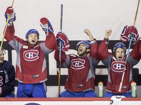 Canadiens players Andrew Shaw, Max Pacioretty and Brendan Gallagher celebrate after a goal during shootout competition at the end of practice in Brossard on Oct. 9, 2016.