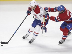 Forward Stefan Matteau receives pressure from defenceman Mark Barberio during Red vs. White scrimmage with Montreal Canadiens players at the Bell Centre in Montreal Sunday, September 25, 2016.