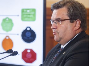 Montreal Mayor Denis Coderre stands next to new animal tags to be issued to cats and dogs, following the vote on banning pit bulls on the territory of the city on Tuesday September 27, 2016. While a judge has struck down parts of the new bylaw, the provisions concerning licences for dogs and cats remain in effect.