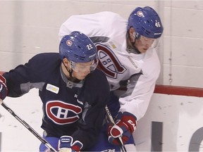 Montreal Canadiens defenceman Mikhail Sergachev (in blue) checks Artturi Lehkonen during a practice at the Bell Sports Complex in Brossard near Montreal Wednesday, Sept. 28, 2016.