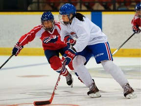 Les Canadiennes' Noémie Marin, left, and Caroline Ouellette take part in a scrimmage during a team practice at Étienne-Desmarteau Arena in Montreal on Thursday September 29, 2016.