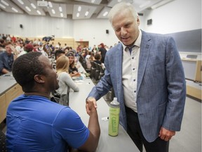 Parti Québécois leadership candidate Jean-Francois Lisée winks at an audience member prior to a debate at Université de Montreal in Montreal on Tuesday Sept. 6, 2016.