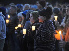 Mourners hold candles Monday, Oct. 10, 2016, during a vigil attended by about 1,000 at Harwood Union High School in Duxbury, Vt.,  for the teenage victims killed in Saturday night's crash on Interstate 89 in Williston.