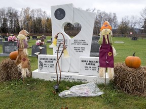 The grave of Noah and Connor Barthe, decorated for Halloween Oct. 30, 2016, in Tide Head, N.B. Jean-Claude Savoie, who lives near Montreal, is charged with criminal negligence causing death after the two young brothers were asphyxiated by an African rock python in Campbellton in August 2013.