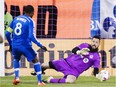 Montreal Impact midfielder Patrice Bernier (8) scores the first goal against Toronto FC goalkeeper Chris Konopka (1) during first half Major League Soccer sudden death playoff game Thursday, October 29, 2015 in Montreal.