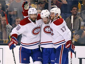 Canadiens' Paul Byron, centre, is congratulated by Andrei Markov (79) and Torrey Mitchell (17) after scoring a short-handed goal during the third period of the Canadiens' 4-2 win over the Boston Bruins in Boston on Saturday, Oct. 22, 2016.