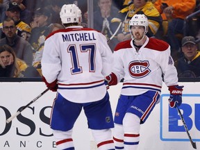Bruins fans look on as Canadiens' Paul Byron is congratulated by Torrey Mitchell (17) after scoring a short-handed goal during the third period of  Montreal's 4-2 win over Boston on Saturday, Oct. 22, 2016.