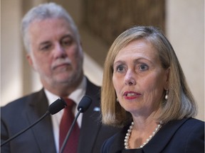 Former Desjardins president Mionique Leroux speaks to reporters after she was nominated by Quebec Premier Philippe Couillard, left, to preside a committee on economy and innovation, Wednesday, October 12, 2016 at his office in Quebec City.