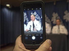 Montreal Chief of Police Philippe Pichet is recorded with a mobile device as he speaks to the media about the tapping of a newspaper reporter's smartphone at a news conference, Monday, October 31, 2016 in Montreal.
